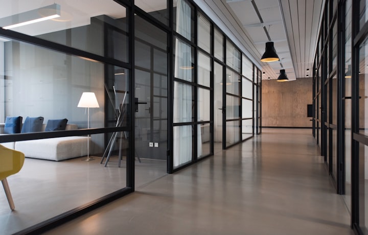 Glass-walled commercial office corridor, professionally cleaned