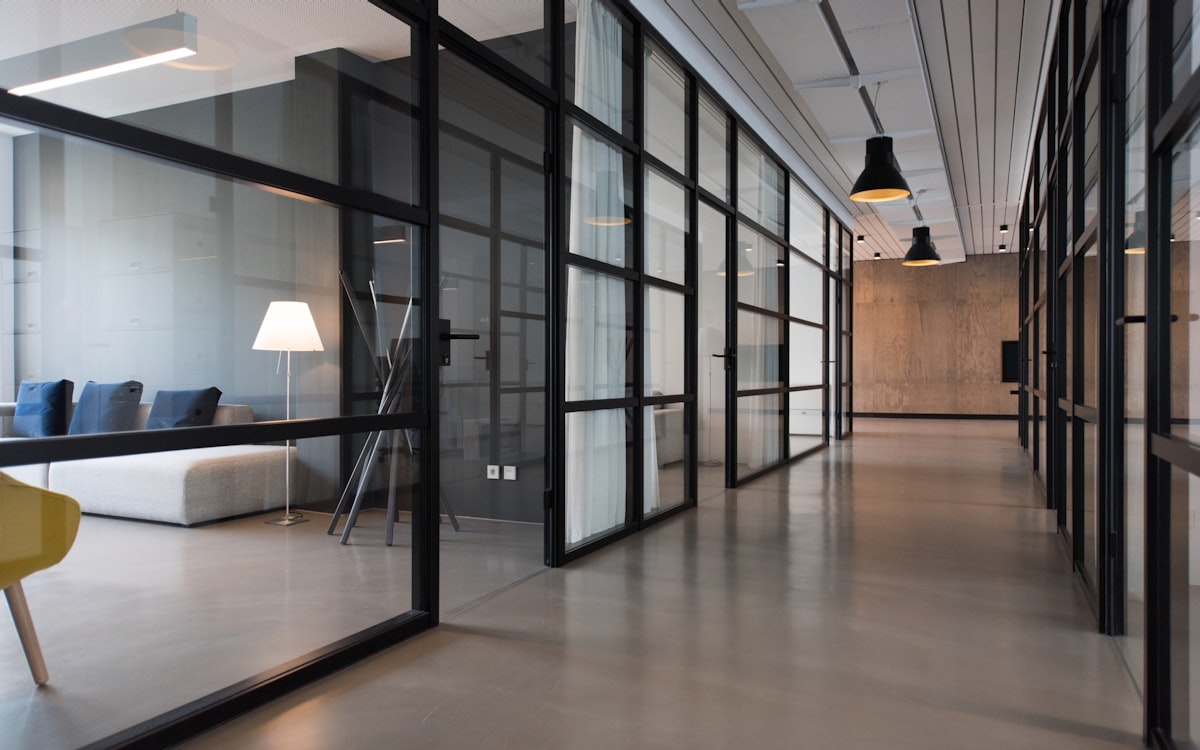 Glass-walled commercial office corridor, professionally cleaned